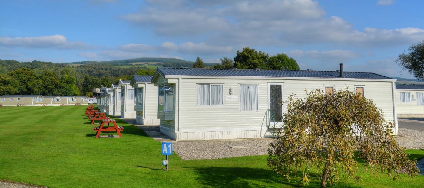 View of holiday homes at Fonab Caravan Park with large green space in the middle